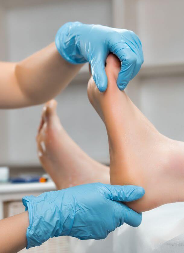 podiatrist checking patients foot